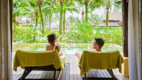 a couple of men and woman on a luxury vacation in Thailand at a 5 star resort relaxing in the swimming pool of a luxury villa in Thailand © Fokke Baarssen