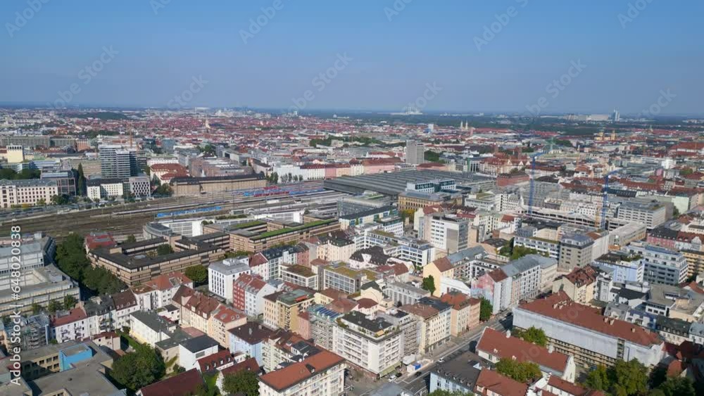 Nice aerial top view flight 
Munich main station in city center, German Bavarian Town at sunny clear sky day 2023. descending drone
4k cinematic