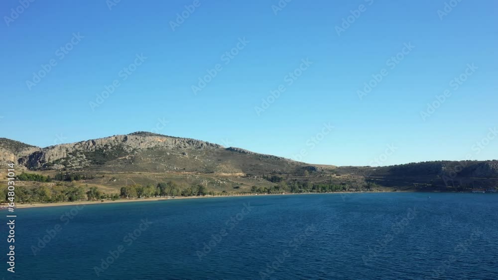 Paralia Karathona Beach at the dry rocky coast and countryside, Europe, Greece, Peloponnese, Argolis, Nafplio, Myrto Sea, summer on a sunny day. Paralia Karathona Beach at the dry rocky coast and countryside, Europe, Greece, Peloponnese, Argolis, Nafplio, Myrto Sea, summer on a sunny day.