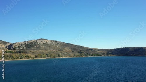 Paralia Karathona Beach at the dry rocky coast and countryside, Europe, Greece, Peloponnese, Argolis, Nafplio, Myrto Sea, summer on a sunny day.  photo