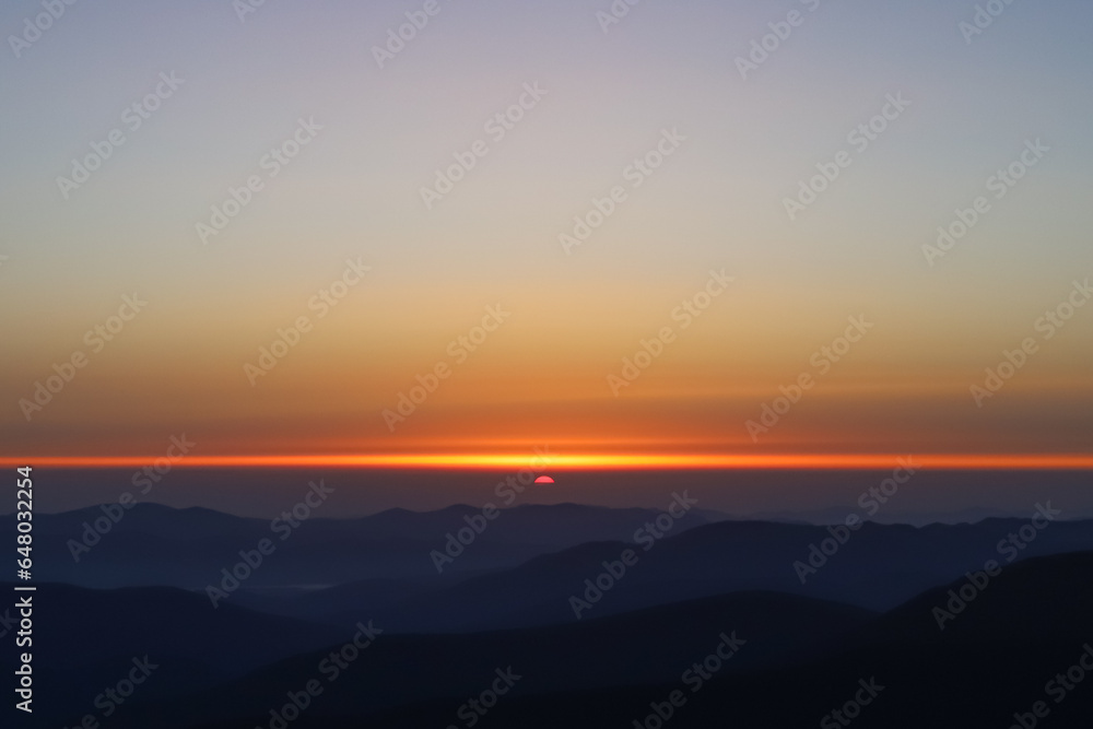 dawn in the mountains, the sun appears on the horizon, the first rays, dark mountains dawn in the mountains, the sun appears on the horizon, the first rays, dark mountains