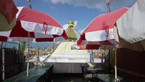 Slow motion pushing through umbrellas to Boudhanath Stupa Nepal