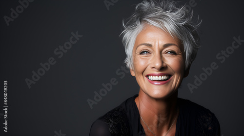 closeup of a joyful senior woman with elegant grey hair, radiantly smiling to showcase her impeccable teeth for a dental advertisement, portrait of a woman