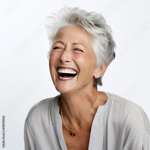 A closeup photo of a elderly senior model woman laughing and smiling with clean teeth on white background