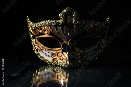 Decorated carnival mask on dark background, close up