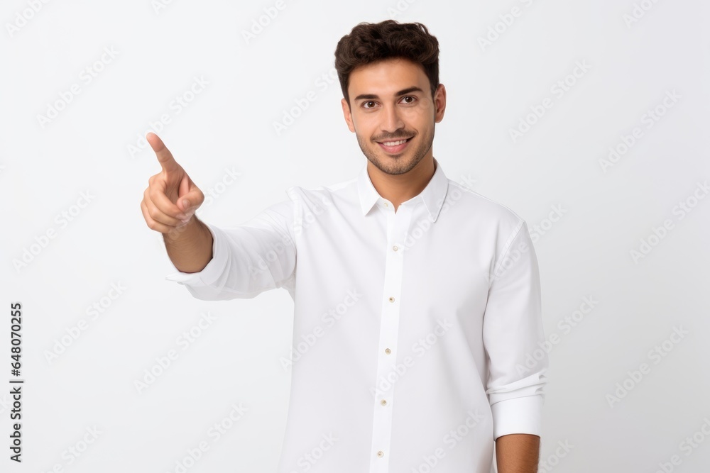 Handsome young man on white background pointing finger Handsome young man on white background pointing finger