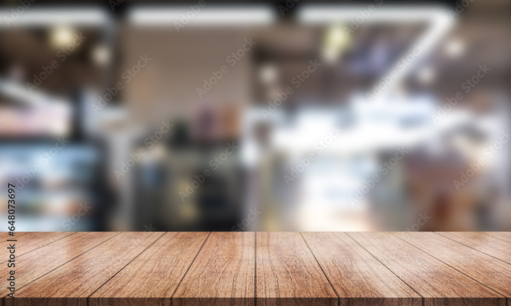 Empty wooden table top with lights bokeh on blur restaurant background.
Empty wooden table top with lights bokeh on blur restaurant background.