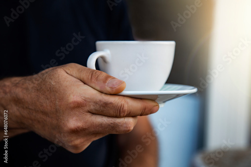 Εκτύπωση καμβά Close-up of man hand holding white cup of coffee or tea on black background