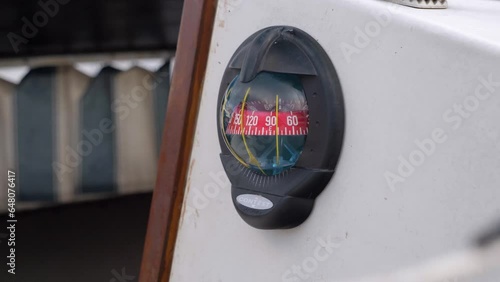 Slow orbiting shot of a gyrocompass giving direction that the captain is sailing photo