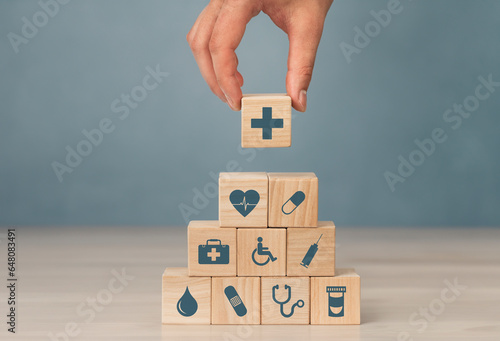 Concept of Insurance for your health, Hand hold wooden block with icon healthcare medical