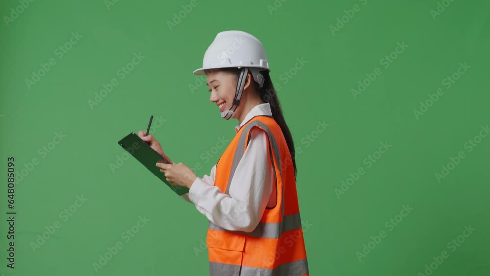 Side View Of Asian Female Engineer With Safety Helmet Taking Note On The Tablet While Walking In The Green Screen Background Studio
Side View Of Asian Female Engineer With Safety Helmet Taking Note On The Tablet While Walking In The Green Screen Background Studio