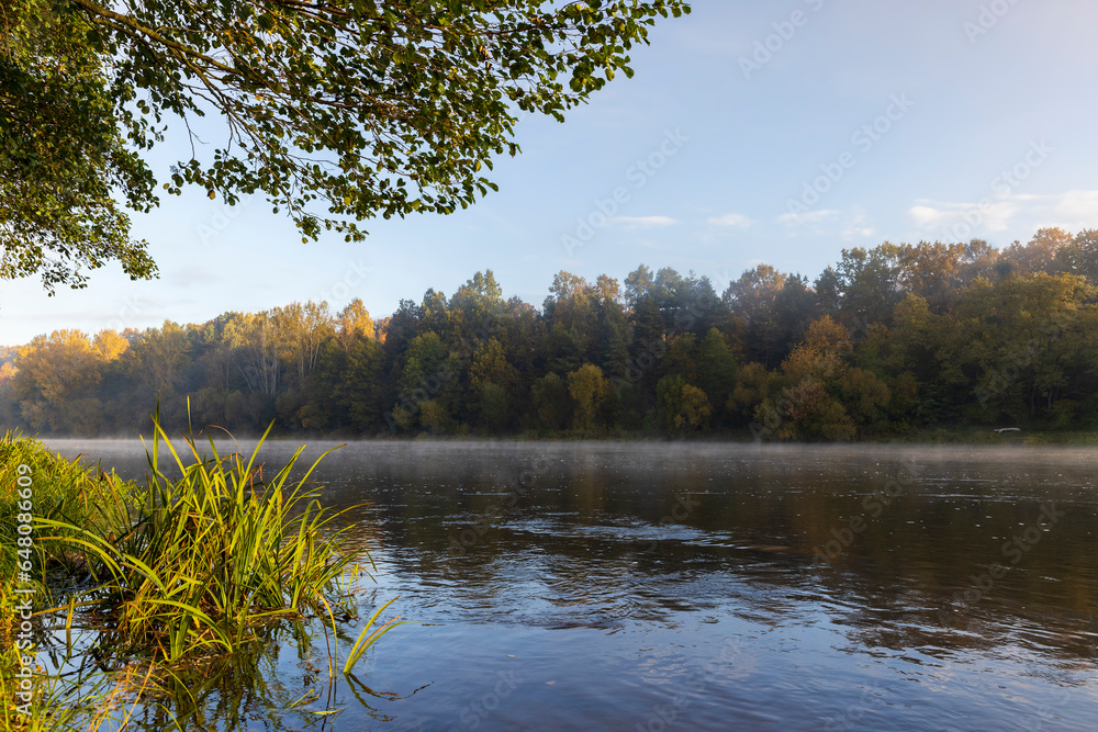 Small fog on the river in autumn