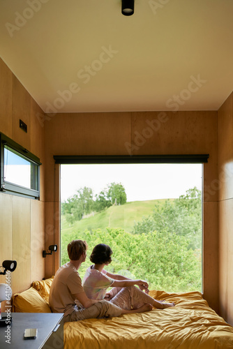 Schilderij op canvas couple enjoying beautiful view on green trees and resting together in country ho