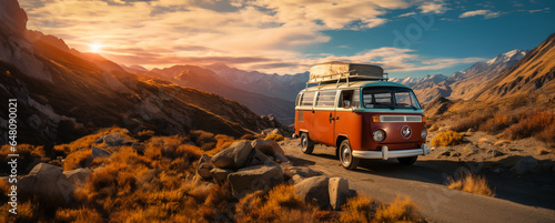 A vintage van traveling at sunset in nature on a canyon path for a road trip to adventure and freedom