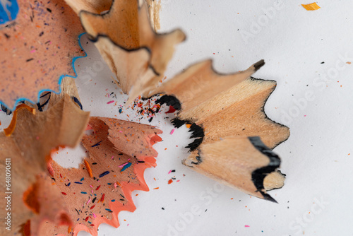 shavings and pieces of lead on paper after sharpening pencils