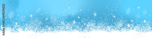 Christmas banner with snow on blue background. Winter border with snowflakes photo