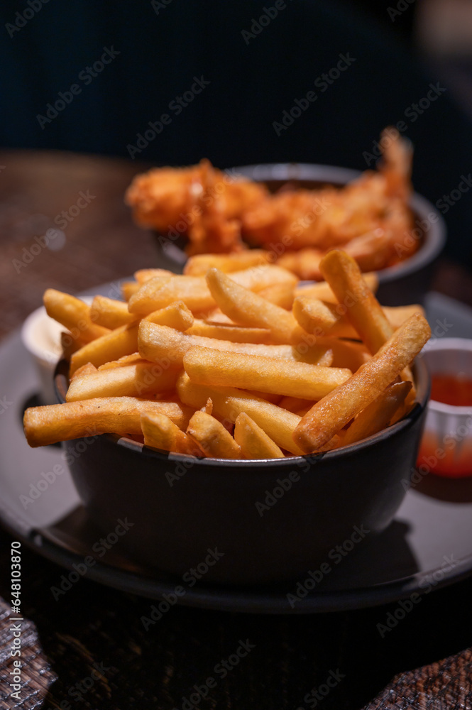 Dutch snacks for beer or wine, french fried potato chips and deep fried tempura shrimps and hot dip sauce Dutch snacks for beer or wine, french fried potato chips and deep fried tempura shrimps and hot dip sauce