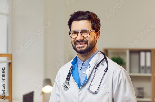 Photography Portrait of cheerful male doctor in white lab coat with stethoscope