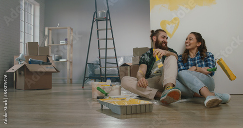 Wallpaper Mural Cheerful young couple in the morning at home. Newlywed caucasian couple are relaxing during renovation of their new home and positively smiling - new life, mortgage concept Torontodigital.ca