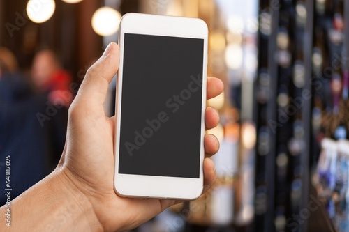 Human hand holding mobile Phone with  blank screem photo