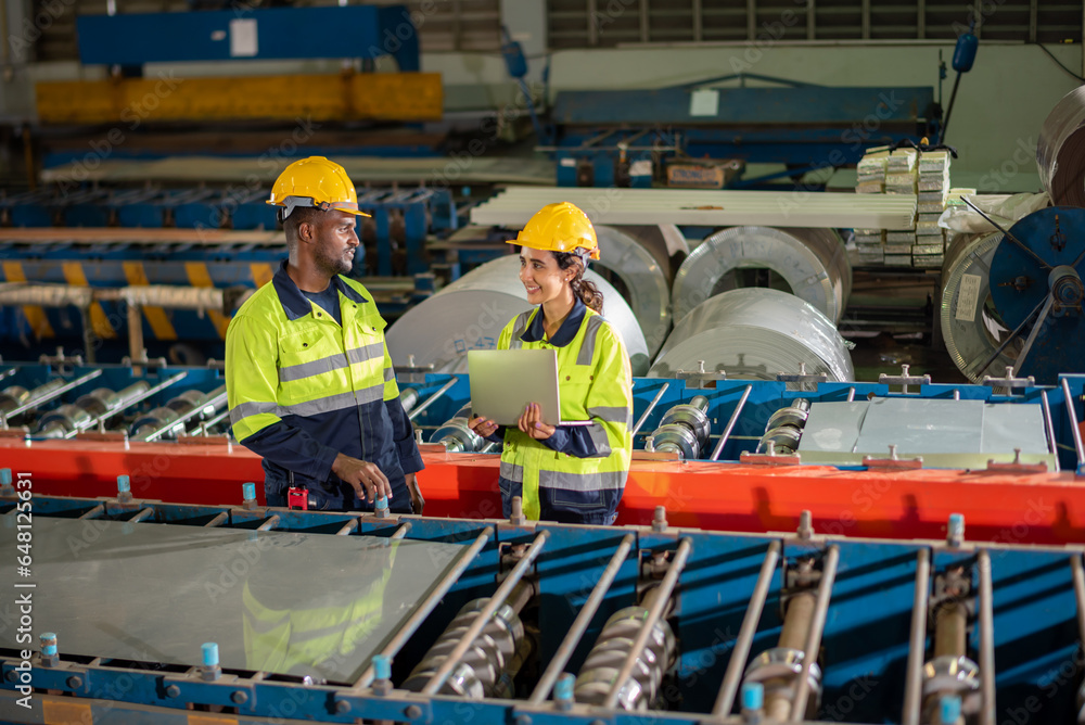 Factory apprenticeship. Man mentor teaching Female employees trainee operating machine looking monitors and check Production process machinery. foreman explaining woman engineer control machine . Factory apprenticeship. Man mentor teaching Female employees trainee operating machine looking monitors and check Production process machinery. foreman explaining woman engineer control machine .