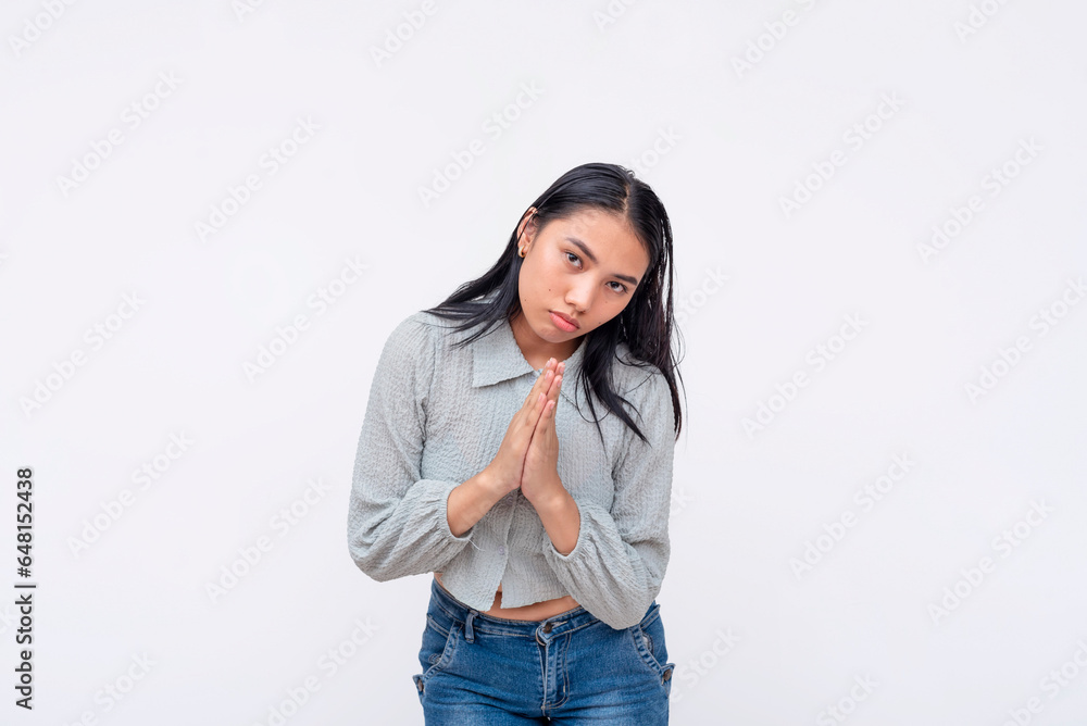 A young asian woman pleads for help, pressuring and making you feel guilty. Isolated on a white background. A young asian woman pleads for help, pressuring and making you feel guilty. Isolated on a white background.