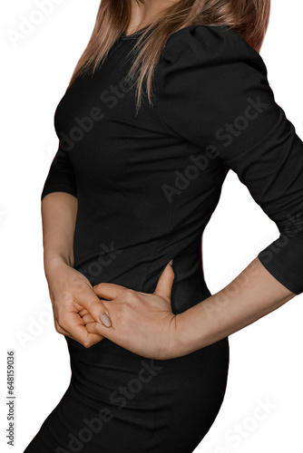 Slim adult girl in black tight-fitting dress posing with hands on waist on white background isolated