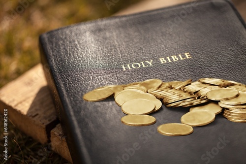Canvas Print Golden coins and Holy Bible book on the desk