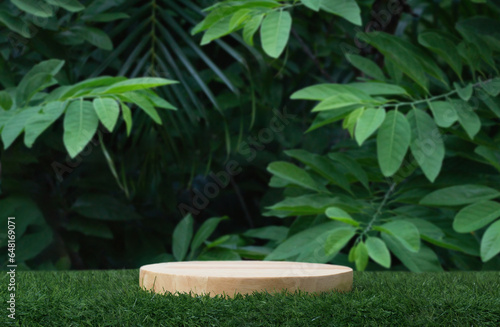 Fototapeta Naklejka Na Ścianę i Meble -  Minimal podium table top outdoors blur green leaf tropical forest plant background.beauty cosmetic healthy natural product placement pedestal display,spring or summer jungle paradise concept.