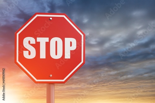 A red alarm stop sign at blue sky background