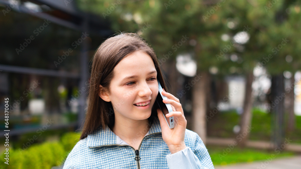 happy smiling with braces teen girl talking on phone walking in city park outdoors happy smiling with braces teen girl talking on phone walking in city park outdoors