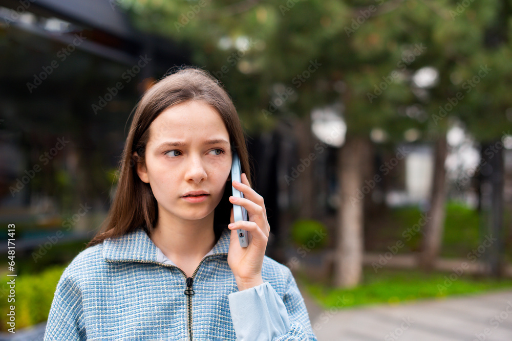 headshot teenager girl calling and speaking on smartphone walking on street headshot teenager girl calling and speaking on smartphone walking on street