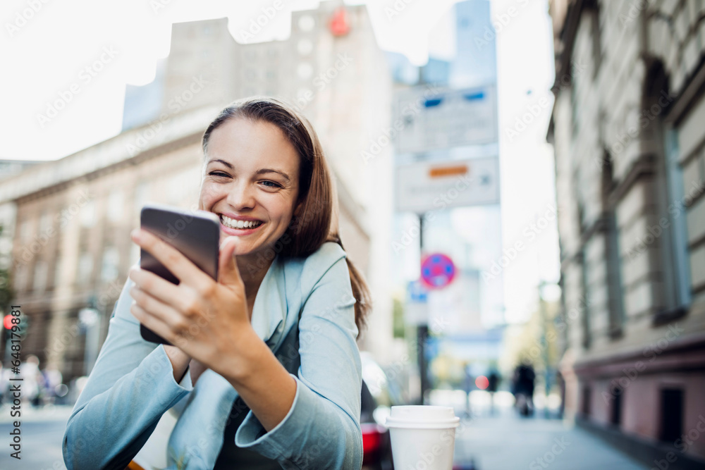 Young Caucasian woman using her smartphone while walking in the city Young Caucasian woman using her smartphone while walking in the city