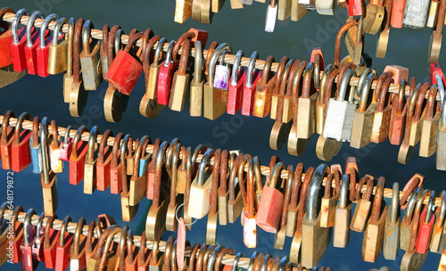 Padlocks hanging from the growling of the Bridge by lovers symbol of their love and union forever