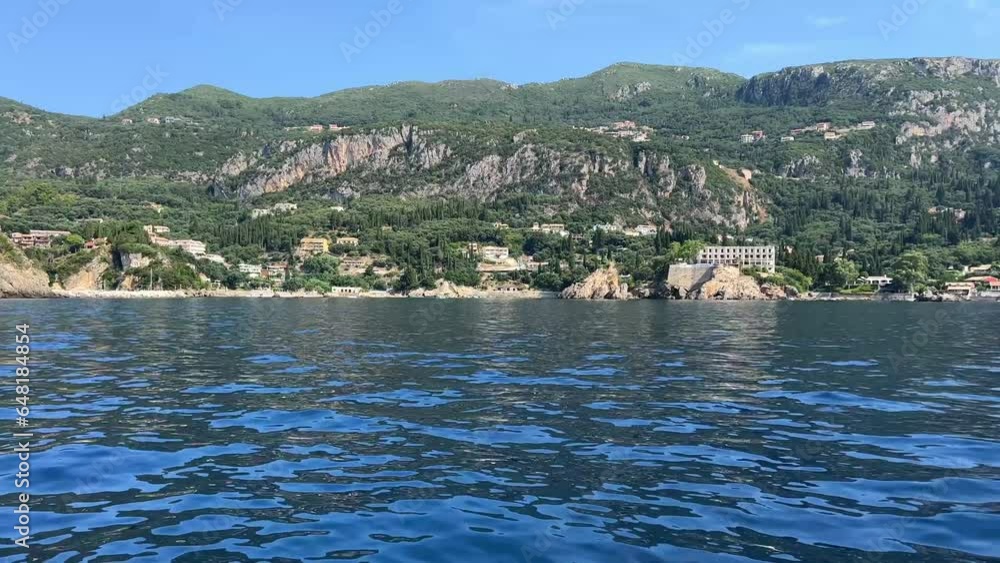 boat tour near Corfu island attractions deep clean clear water mountains natural spring passing boat people. tourists and travelers boat tour near Corfu island attractions deep clean clear water mountains natural spring passing boat people. tourists and travelers