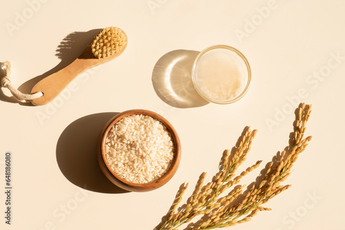 Homemade healthy rice water - natural toner for skin and hair care. Eco cosmetics. Flat lay composition with rice water and ears of rice. Natural cosmetics product background. Earth tones