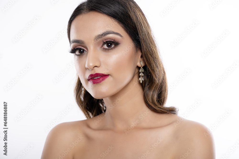 Young Indian female model portrait in white dress. High key portrait of Indian female model Young Indian female model portrait in white dress. High key portrait of Indian female model