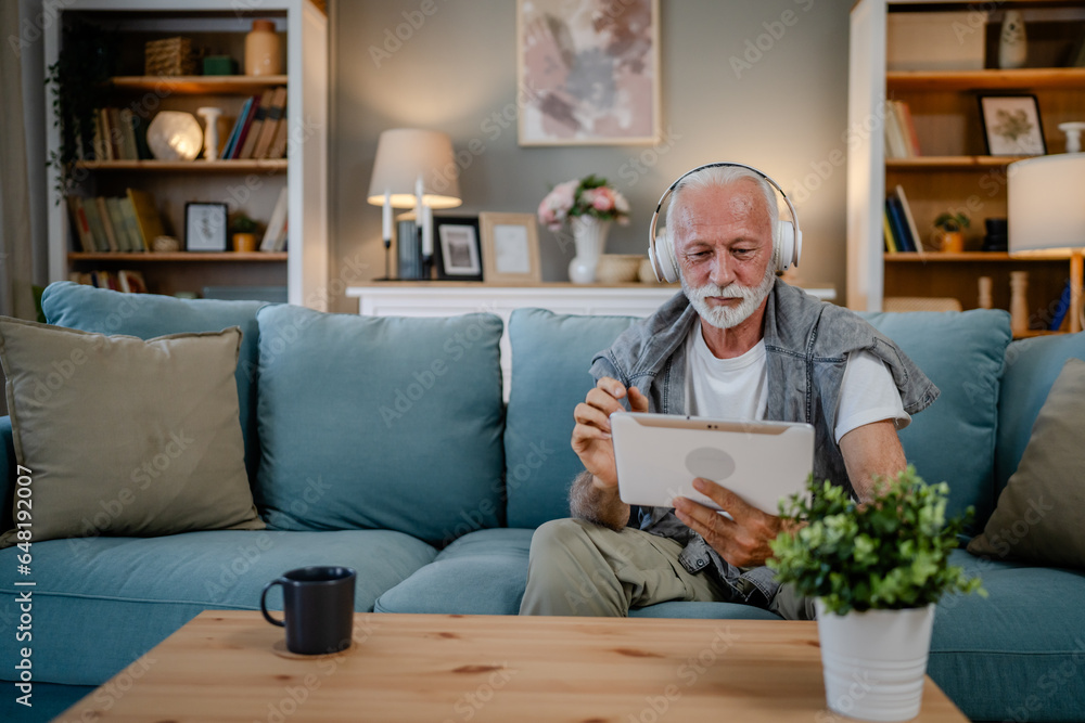 One senior man use digital tablet to watch movie or have a video call One senior man use digital tablet to watch movie or have a video call