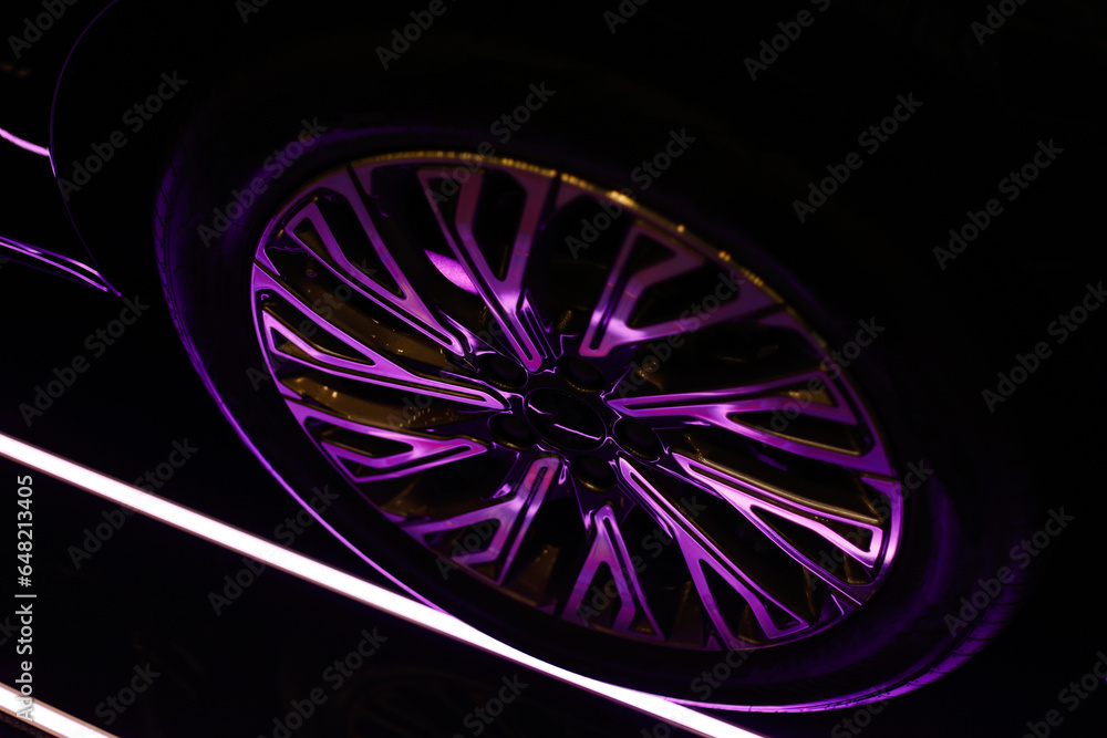 Car alloy wheel texture background in pink tones. New alloy wheel for a car. Modern alloy rim. Car wheel disc Car alloy wheel texture background in pink tones. New alloy wheel for a car. Modern alloy rim. Car wheel disc