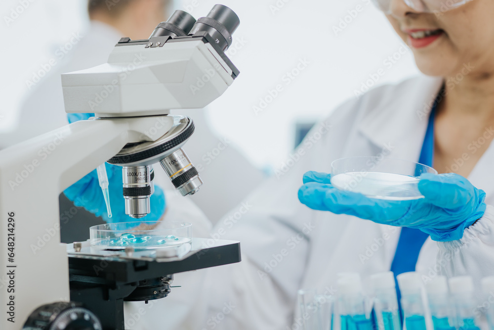 Modern medical laboratory: two scientists work with micropipettes Analyze biochemical samples Advanced Medical Science Laboratory Modern medical laboratory: two scientists work with micropipettes Analyze biochemical samples Advanced Medical Science Laboratory