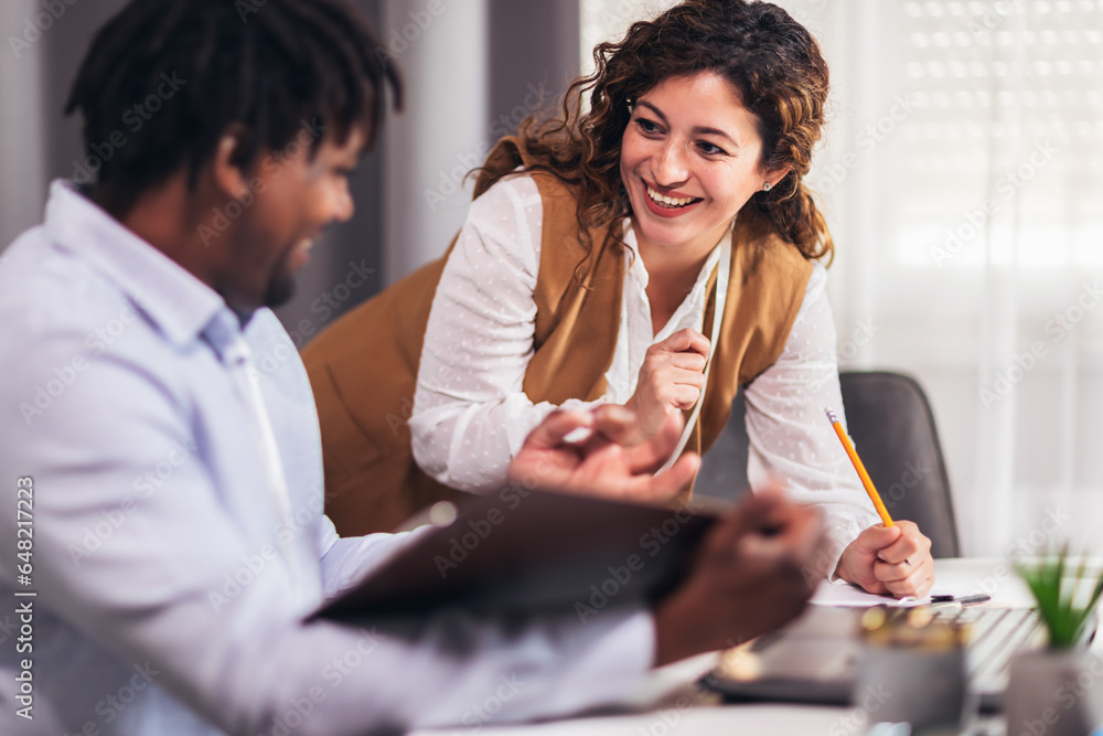 Portrait of young business people working together in home office. Couple teamwork startup concept Portrait of young business people working together in home office. Couple teamwork startup concept