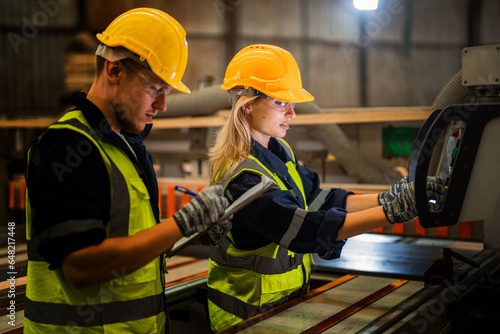 actory engineer workers standing to control panel switch. people works at heavy machine at industry factory. with machinery equipment plant technology. smart industry worker operating. photo