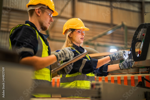 actory engineer workers standing to control panel switch. people works at heavy machine at industry factory. with machinery equipment plant technology. smart industry worker operating. photo