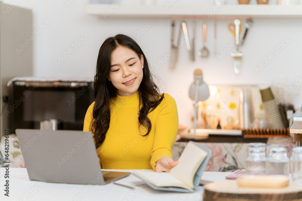 Young Asian businesswoman working using laptop computer on desk at freelance home. Relax. Stretching. Lifestyle of women studying and doing business online business and education concept Young Asian businesswoman working using laptop computer on desk at freelance home. Relax. Stretching. Lifestyle of women studying and doing business online business and education concept