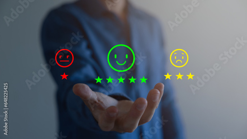 Customer Service and Satisfaction Concept Businessmen touch the virtual screen on happy smiley icons to achieve service satisfaction and feedback with excellent rated reviews.