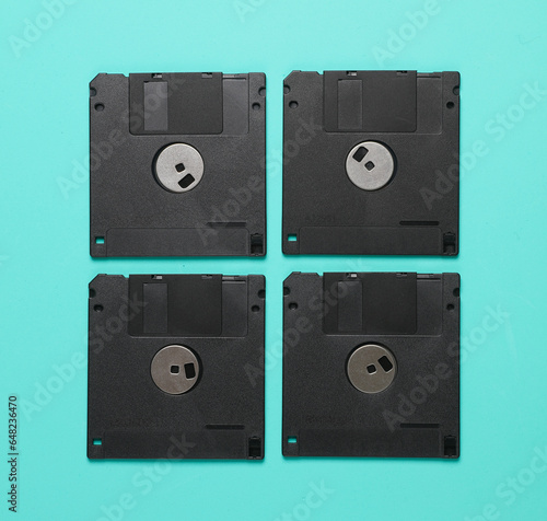 Black floppy disks on a blue background. Retro 80s