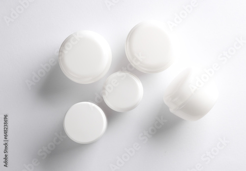 White cream jars on white background. Creative layout. Template for design. Mockup. Minmal beauty concept.