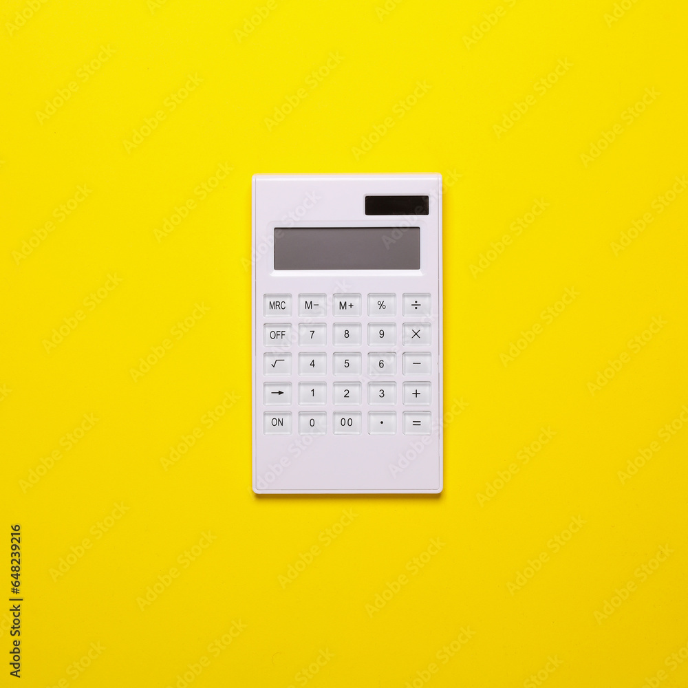 White calculator on a yellow background. Minimalism Business concept White calculator on a yellow background. Minimalism Business concept