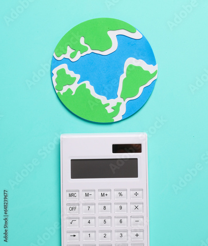Calculator and globe on a blue background. Global economy