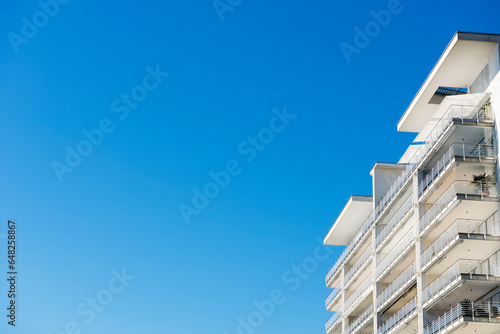 Balconies on a building against a blue sky photo